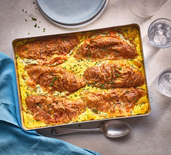 Baked croissants with eggs in a tray