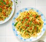 Two servings of aglio e olio with sundried tomato breadcrumbs