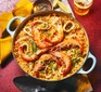 Arroz con gambas y calamar in a large pan