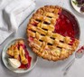 Next level blackberry pie in a pie dish with a single serving alongside