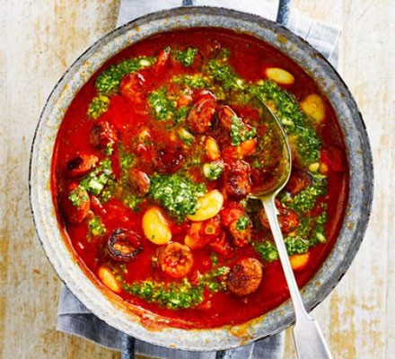 Butter bean & chorizo stew in a pan with a spoon