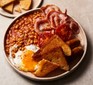 Full English breakfast on a plate with fried bread