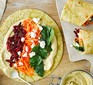 An open hummus rainbow wrap