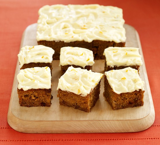 Halloween pumpkin cake cut into slices on a board