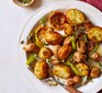 Sausages with lemon & rosemary roast potatoes served on a large plate