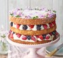 Summer berry cake with rose geranium cream served on a cake stand