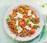 A bowl of toasted orzo with cherry tomatoes and mozzarella