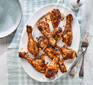 A selection of baked chicken drumsticks on a plate